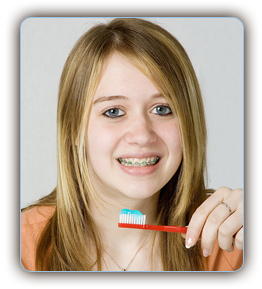stock photo of a teen girl with braces brushing her teeth